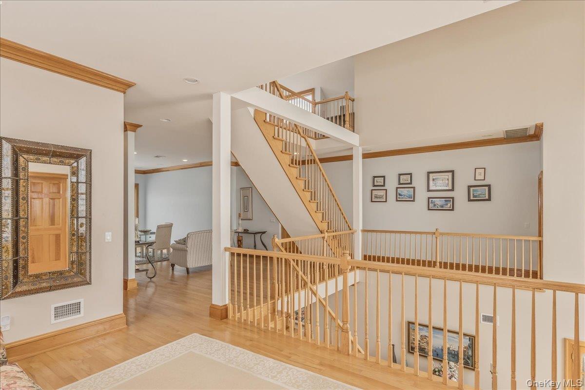 672 Dune Road Westhampton Beach, NY 11978 - Photo 24 of 38 a view of staircase with white walls and a rug