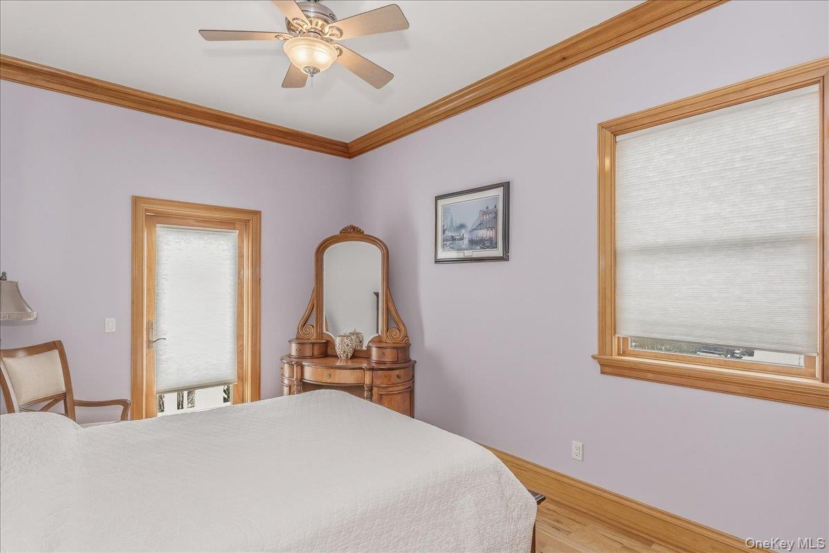 672 Dune Road Westhampton Beach, NY 11978 - Photo 26 of 38 a bedroom with a bed and a chandelier