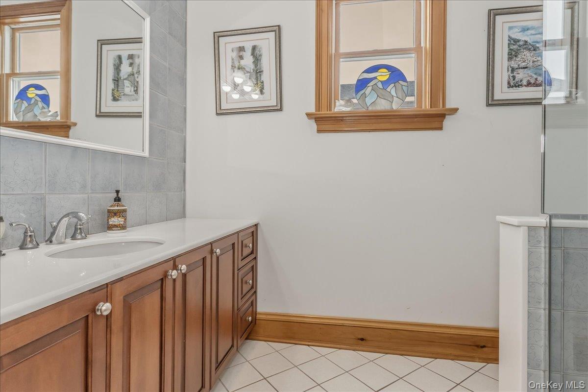 672 Dune Road Westhampton Beach, NY 11978 - Photo 27 of 38 a bathroom with a sink and a mirror