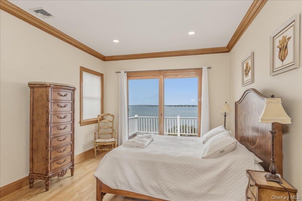 672 Dune Road Westhampton Beach, NY 11978 - Photo 29 of 38 a bed room with a bed and a chair