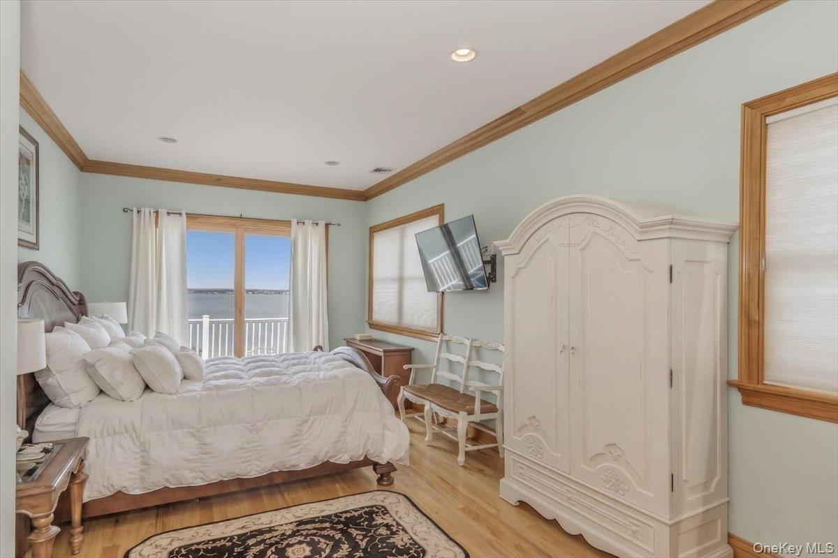 672 Dune Road Westhampton Beach, NY 11978 - Photo 31 of 38 a bedroom with a bed dresser and a window