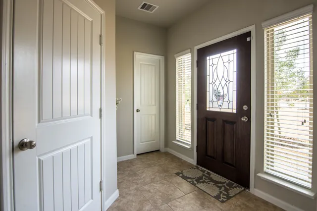 a view of a dining room with furniture and a window
