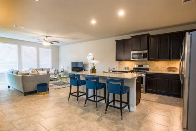 a living room with lots of furniture and a large window