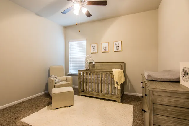 a bathroom with a double vanity sink toilet and a mirror