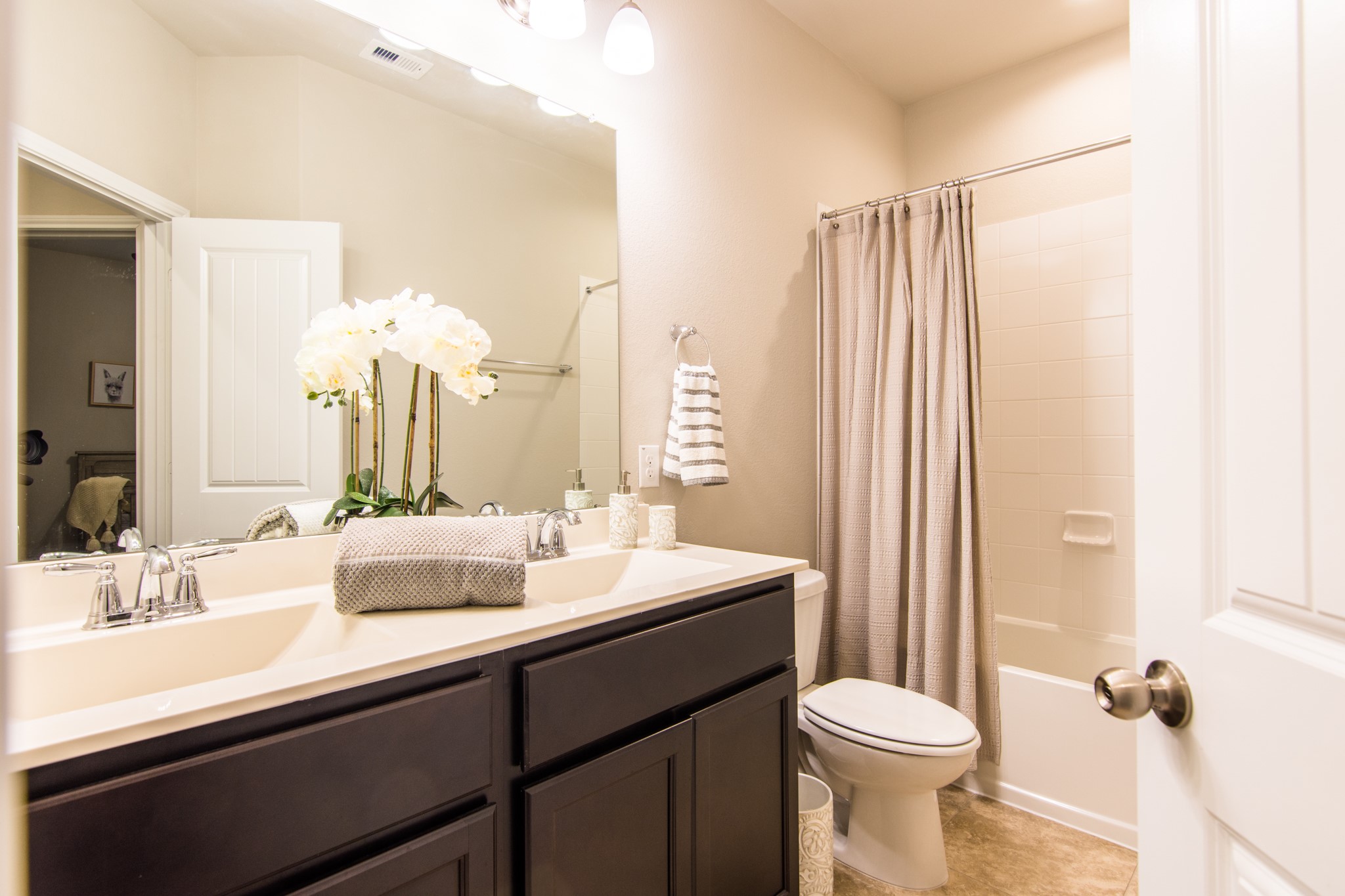 3311 Rainflower Springs Lane Rosenberg, TX 77471 - Photo 29 of 35 a bathroom with a double vanity sink toilet and a mirror