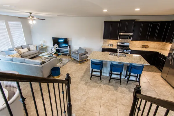 a living room with furniture a flat screen tv and a table