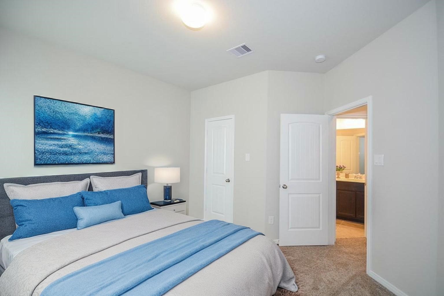 3311 Rainflower Springs Lane Rosenberg, TX 77471 - Photo 31 of 35 a bedroom with a bed and a painting on the wall