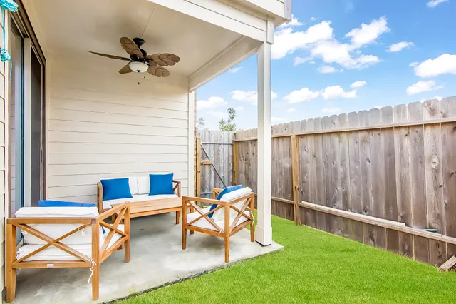 a view of a porch with furniture and a backyard