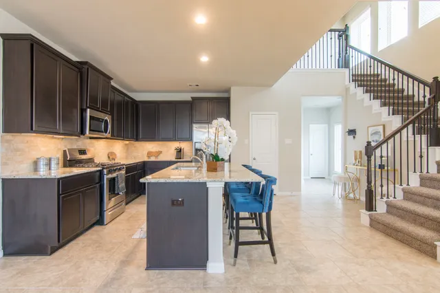 a kitchen with granite countertop a sink and cabinets