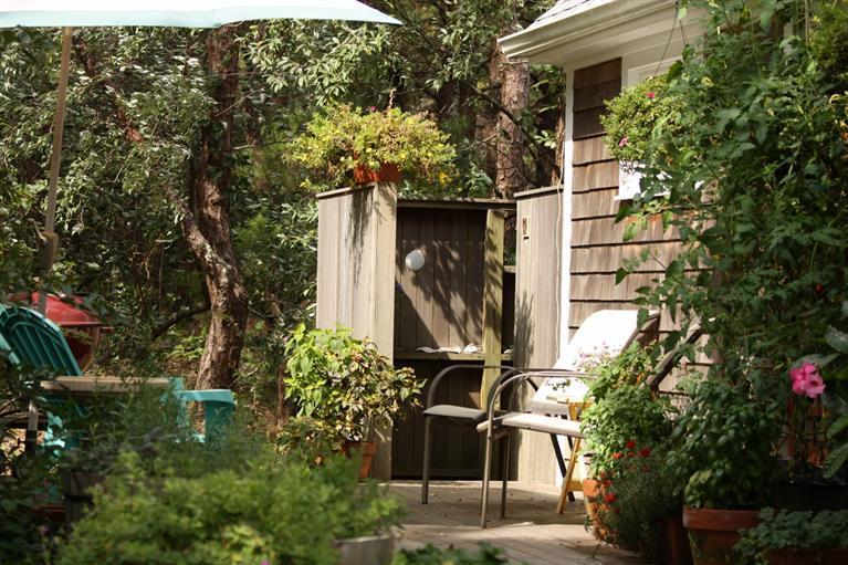 25 Crowell Road Wellfleet, MA 02667 - Photo 21 of 26 a yellow house with trees in front of it
