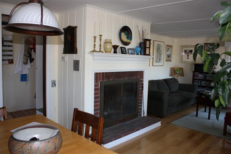 25 Crowell Road Wellfleet, MA 02667 - Photo 8 of 26 a living room with furniture and a fireplace