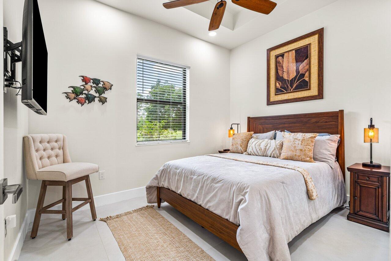 12466 Quercus Lane, Unit GUEST HOUSE Wellington, FL 33414 - Photo 11 of 24 a bedroom with a bed and a painting on the wall