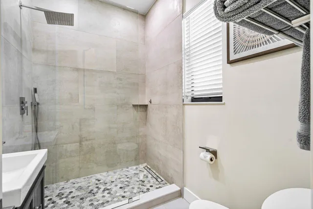 a bathroom with a sink a toilet a shower and a bathtub