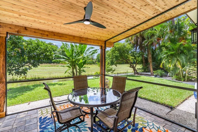 a view of a patio with a table chairs and a backyard