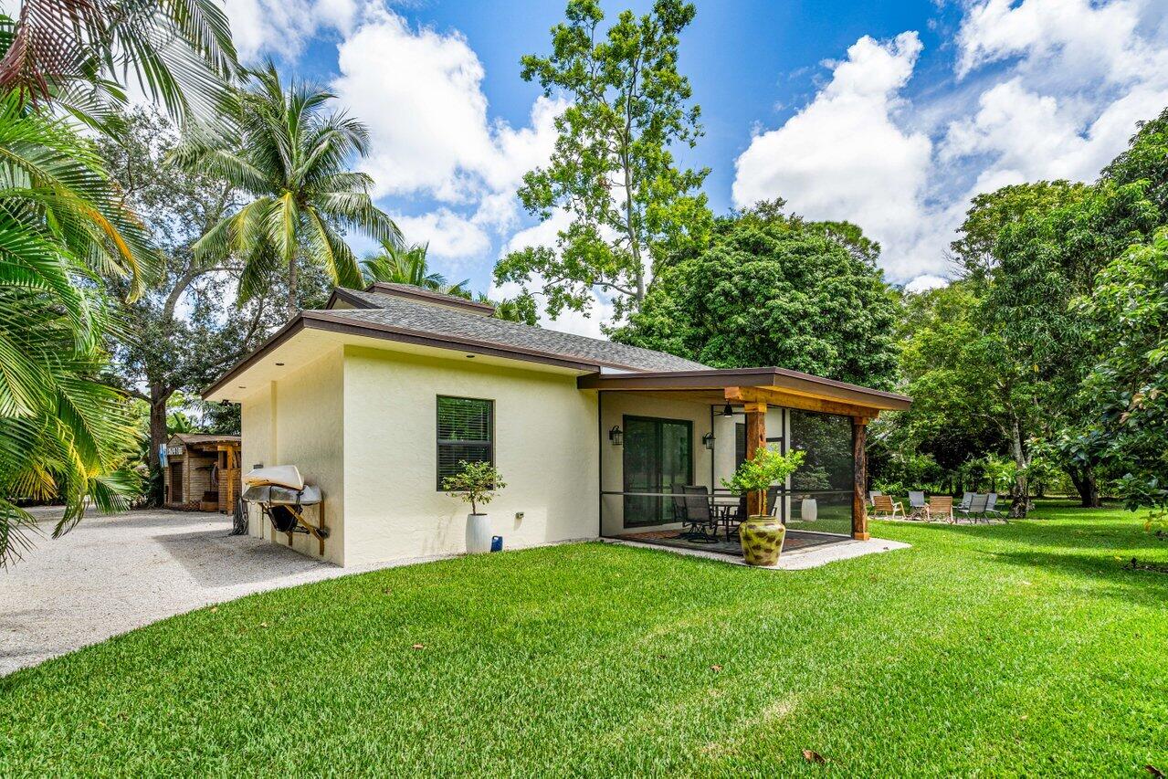 12466 Quercus Lane, Unit GUEST HOUSE Wellington, FL 33414 - Photo 16 of 24 a view of outdoor space yard and patio
