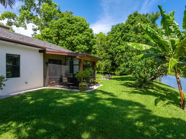 a view of a house with a yard and sitting area