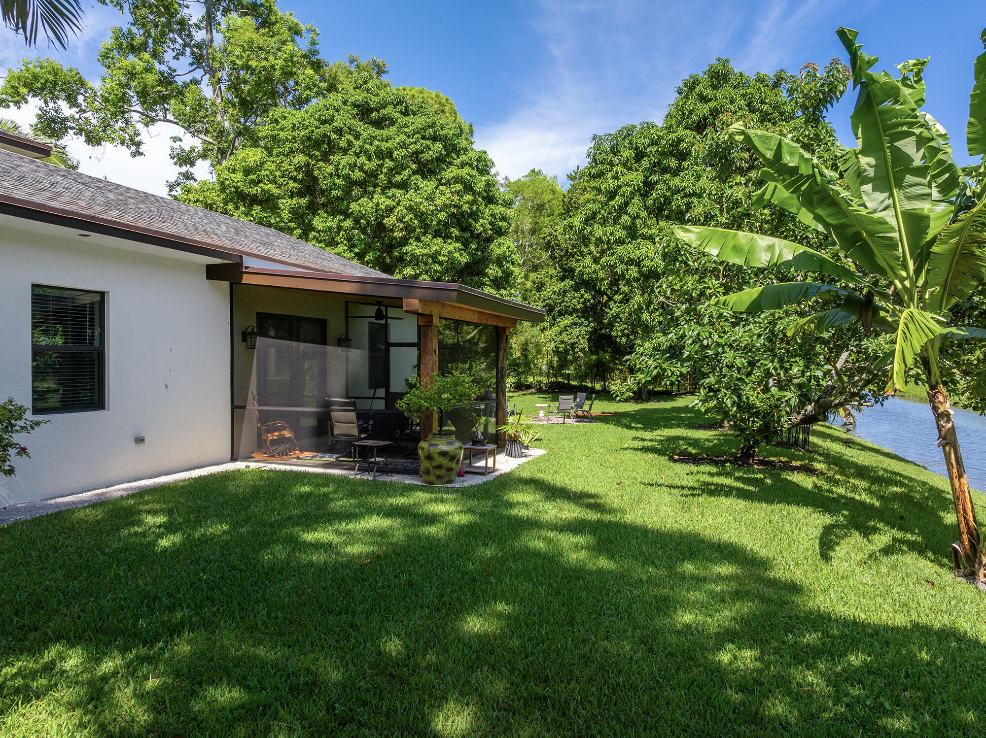 12466 Quercus Lane, Unit GUEST HOUSE Wellington, FL 33414 - Photo 17 of 24 a view of a house with a yard and sitting area