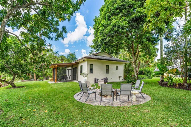 a view of a house with a yard and sitting area