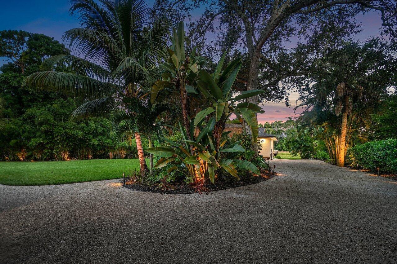 12466 Quercus Lane, Unit GUEST HOUSE Wellington, FL 33414 - Photo 21 of 24 a view of a house with a tree and a yard