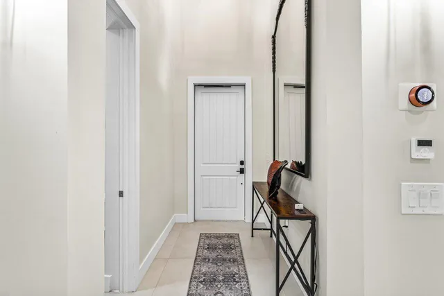 a view of an entryway with table and mirror