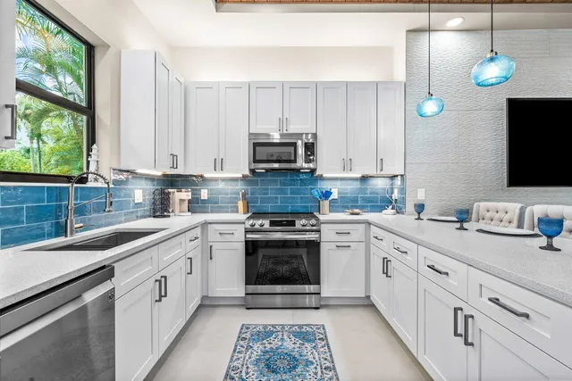 a kitchen with appliances cabinets and a sink