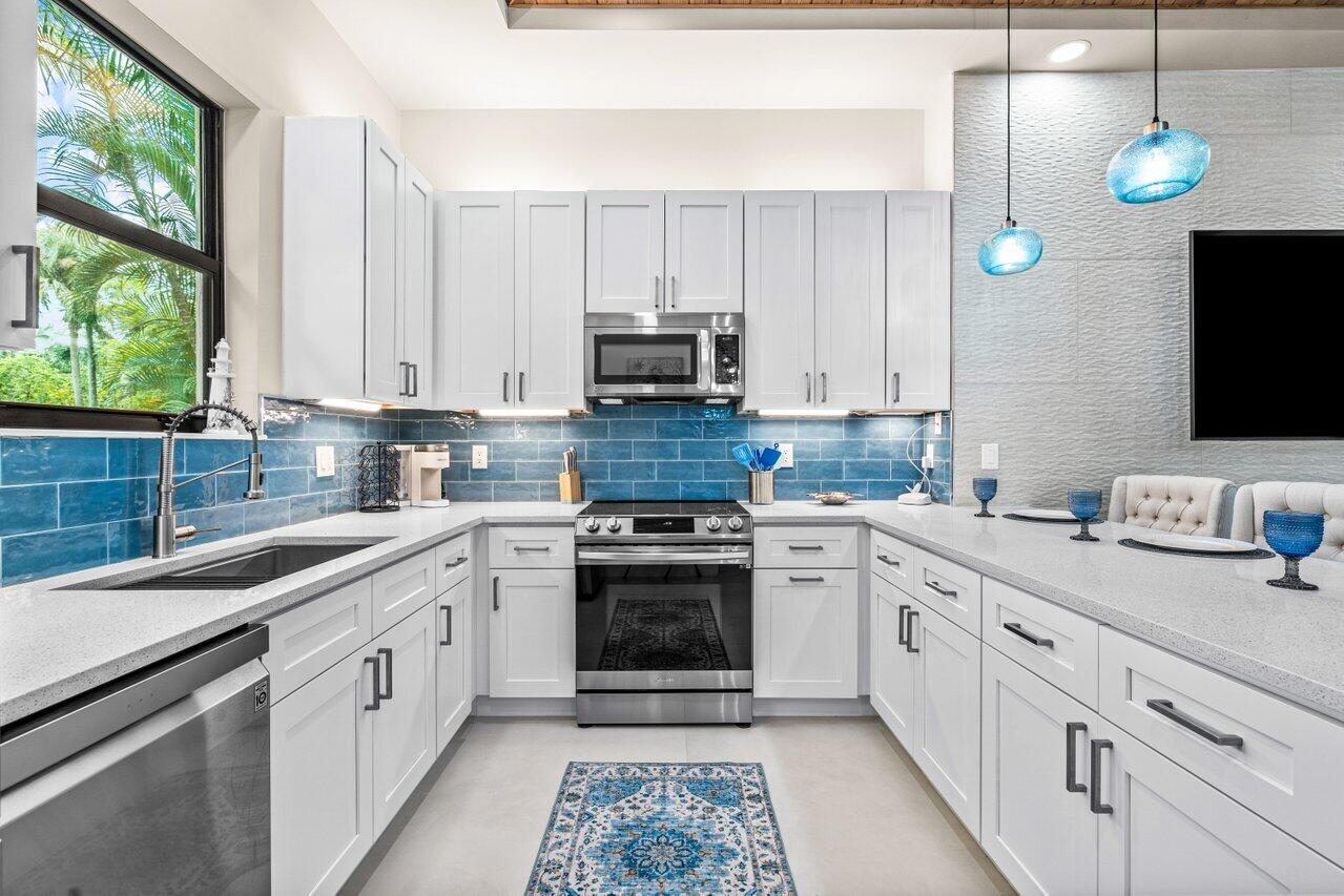 12466 Quercus Lane, Unit GUEST HOUSE Wellington, FL 33414 - Photo 4 of 24 a kitchen with appliances cabinets and a sink