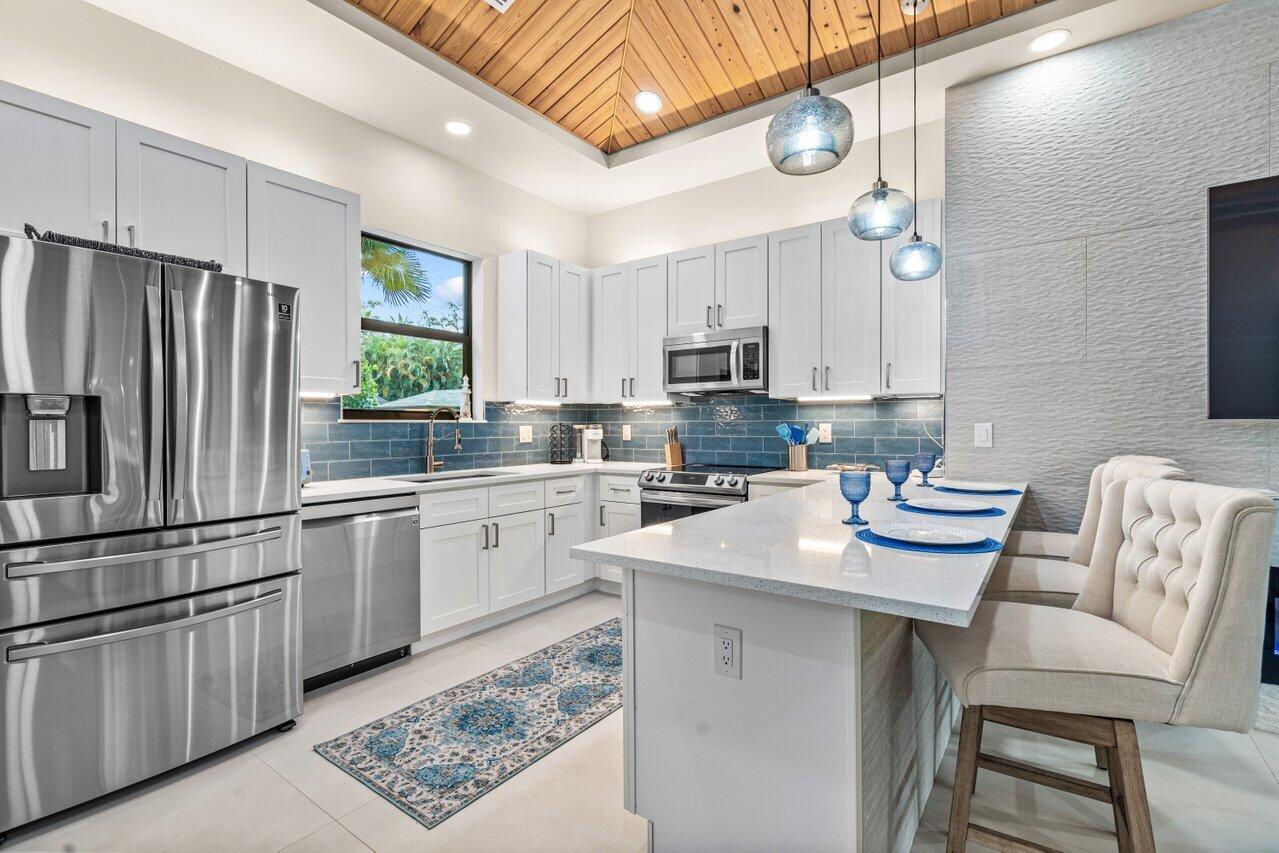 12466 Quercus Lane, Unit GUEST HOUSE Wellington, FL 33414 - Photo 5 of 24 a kitchen with a sink cabinets and window