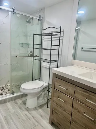 a bathroom with a toilet and a shower