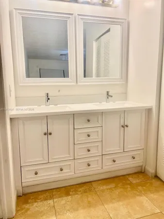 a bathroom with a sink vanity and mirror