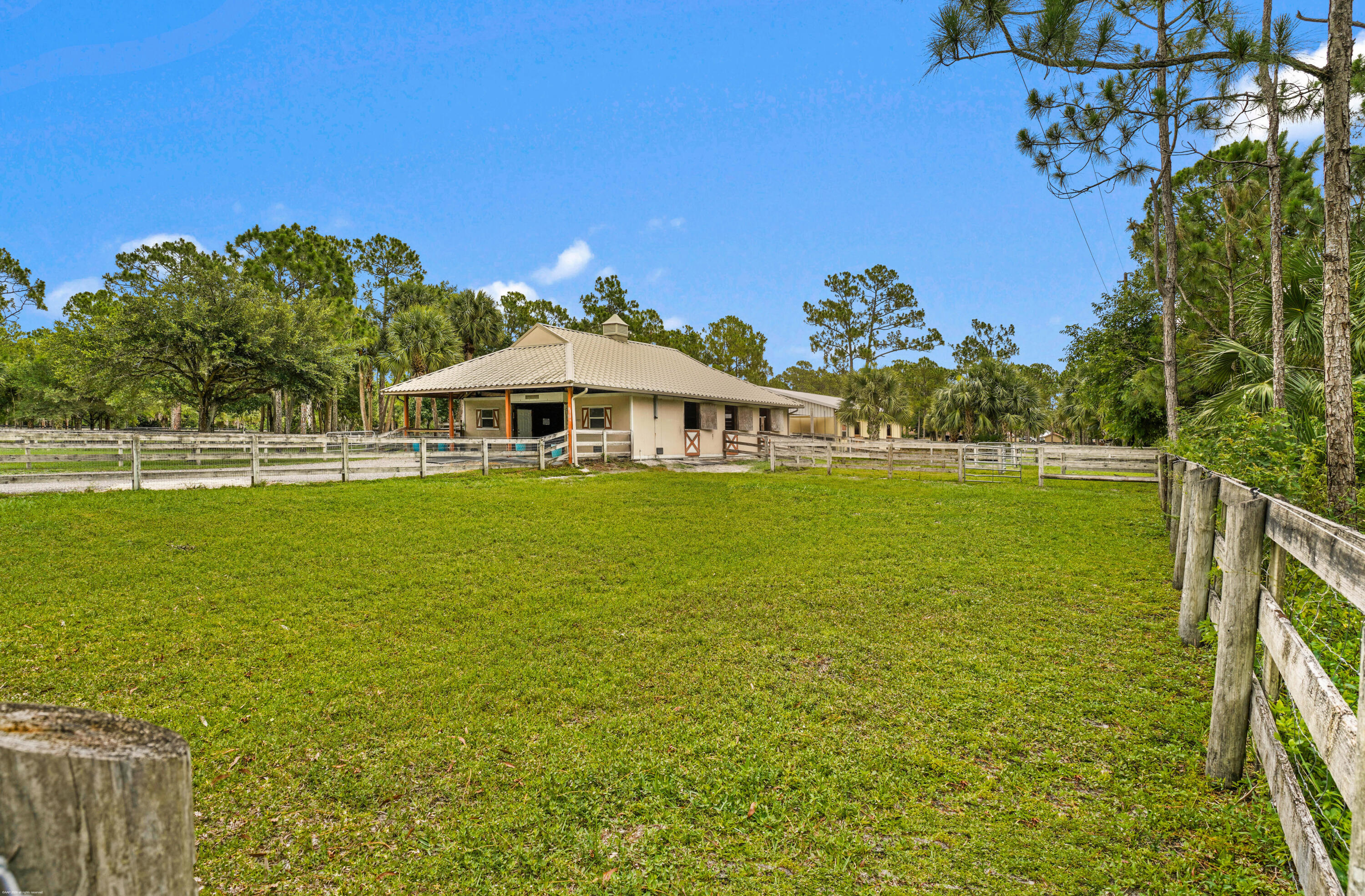 2560 Buck Ridge Trail Loxahatchee, FL 33470 - Photo 48 of 65 Stables & turnout paddock.