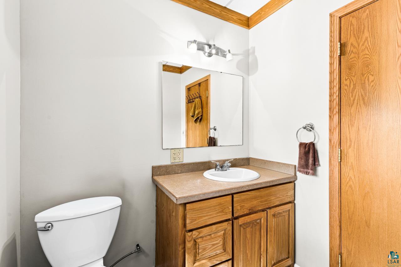 4800 Tower Road Moose Lake, MN 55767 - Photo 64 of 83 Bathroom vanity with wood-finish cabinetry and a single basin sink