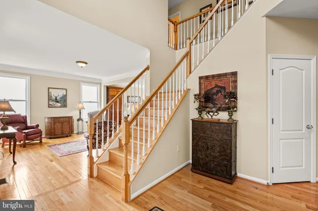 a kitchen with stainless steel appliances granite countertop wooden floor window and cabinets