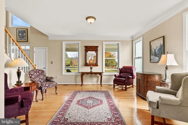 a view of a hallway with wooden floor and entryway
