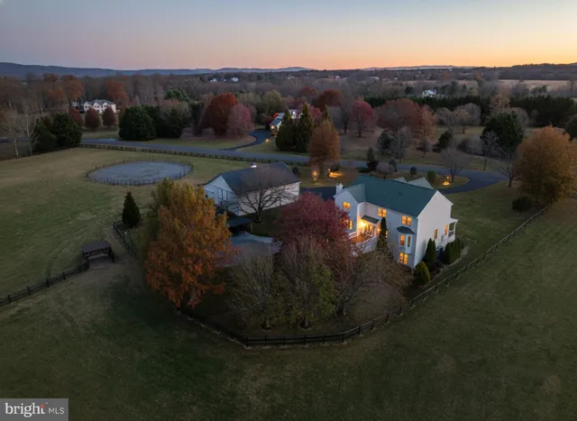 a house with swimming pool in front of it