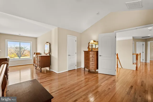 a view of backyard with barbeque grill potted plants and a large tree
