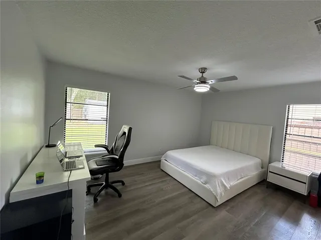 a bedroom with a bed a desk and chair