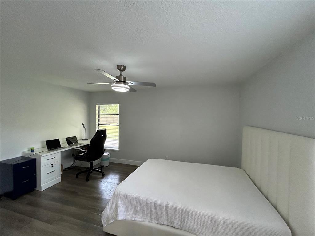 3926 Greenview Pines Court Orlando, FL 32817 - Photo 13 of 28 a workspace with wooden floor