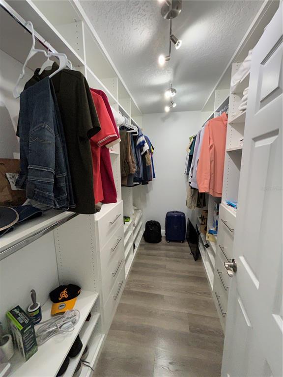 3926 Greenview Pines Court Orlando, FL 32817 - Photo 14 of 28 a view of walk in closet with clothes and shoes
