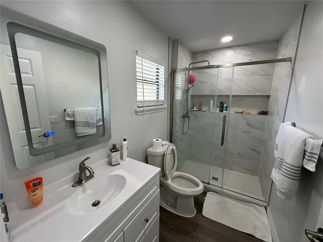 a bathroom with a sink toilet and shower
