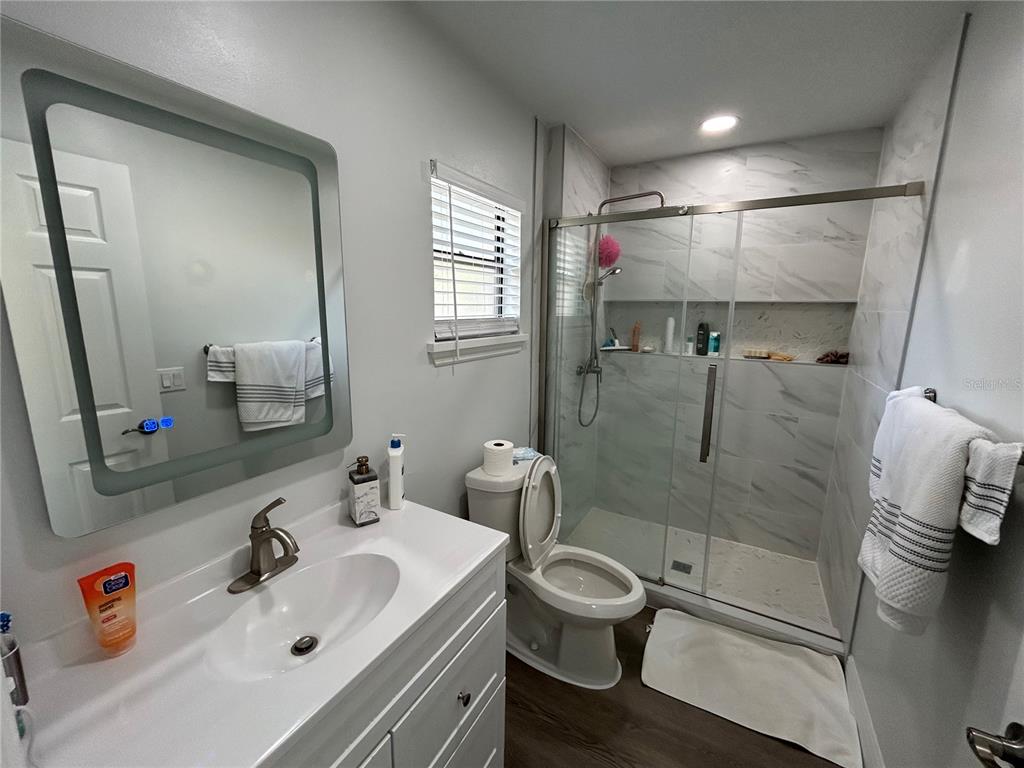 3926 Greenview Pines Court Orlando, FL 32817 - Photo 15 of 28 a bathroom with a sink toilet and shower