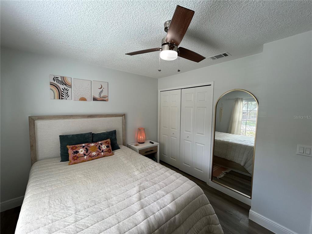 3926 Greenview Pines Court Orlando, FL 32817 - Photo 16 of 28 a bedroom with a bed and a fireplace