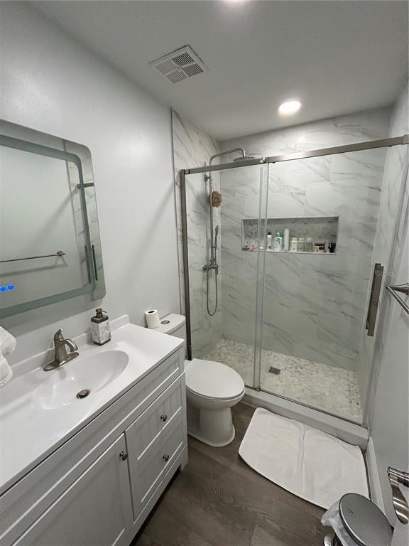 3926 Greenview Pines Court Orlando, FL 32817 - Photo 18 of 28 a bathroom with a double vanity sink toilet and shower