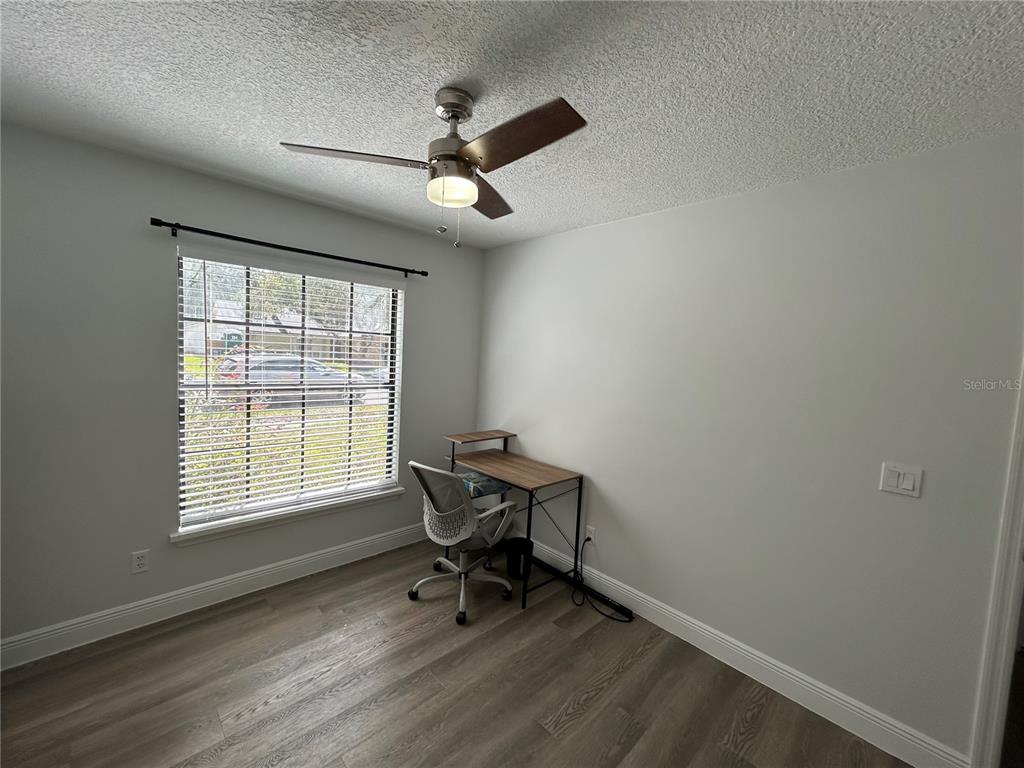 3926 Greenview Pines Court Orlando, FL 32817 - Photo 19 of 28 a workspace with wooden floor and a window