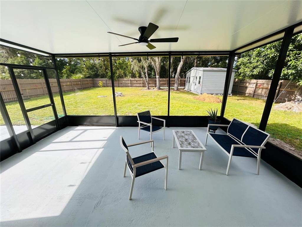 3926 Greenview Pines Court Orlando, FL 32817 - Photo 23 of 28 a view of a living room with furniture and a flat screen tv