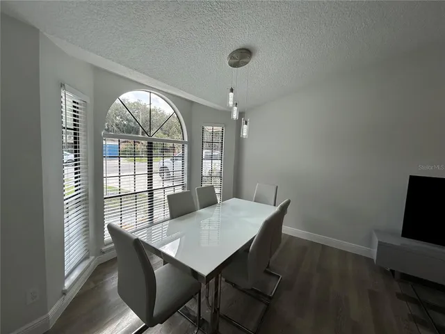 a view of a dining room with furniture window and outside view