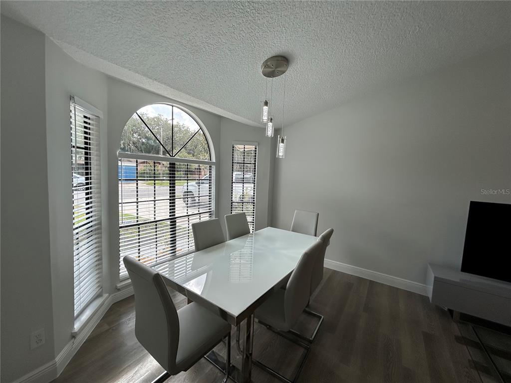 3926 Greenview Pines Court Orlando, FL 32817 - Photo 3 of 28 a view of a dining room with furniture window and outside view