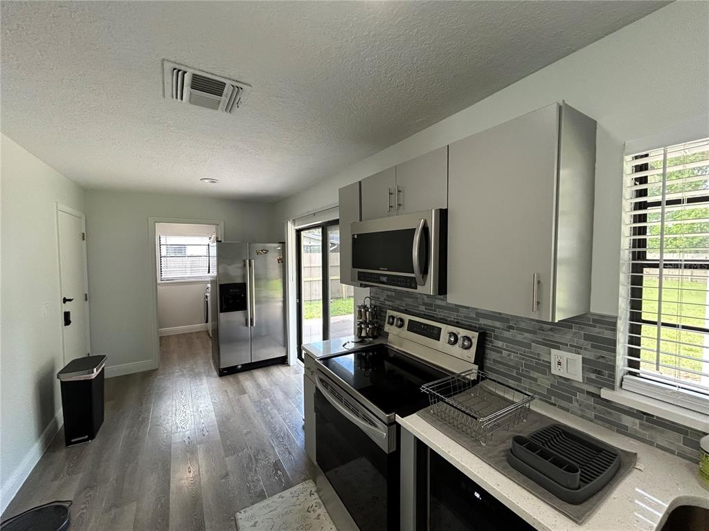 3926 Greenview Pines Court Orlando, FL 32817 - Photo 10 of 28 a kitchen with sink stove and refrigerator