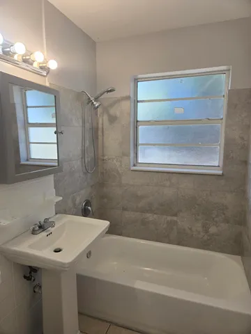 a bathroom with a sink a bathtub and a shower