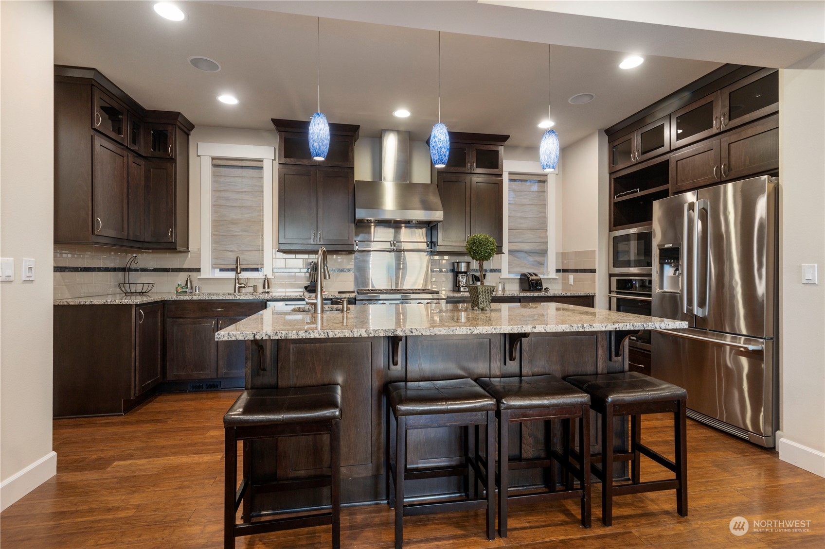 3318 Lake Washington Boulevard North Renton, WA 98056 - Photo 15 of 40 a kitchen with a table chairs refrigerator microwave and cabinets