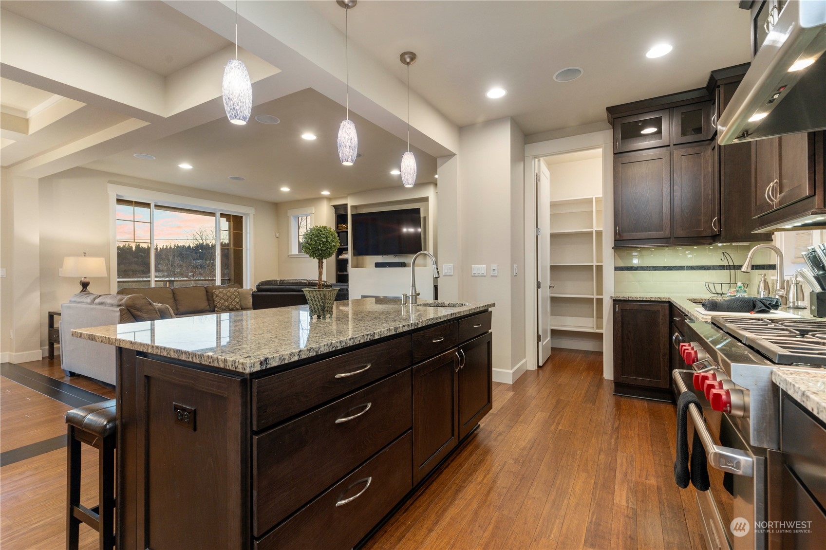 3318 Lake Washington Boulevard North Renton, WA 98056 - Photo 17 of 40 a kitchen with stainless steel appliances granite countertop wooden cabinets a sink dishwasher a stove and a refrigerator with wooden floor